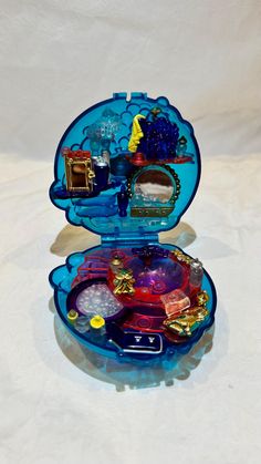 an open blue case with various items inside on a white surface