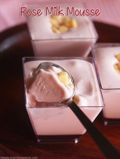 three square glass dishes filled with ice cream and pineapple chunks, one being spooned into the other