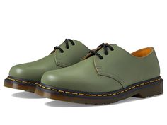 Dr. Martens 1461 Smooth Leather Shoes - Shoes : Khaki Green Smooth : The Dr. Martens 1461 oxford shoes are a tried-and-true classic that are a timeless addition to your wardrobe. The premium leather upper has a traditional lace-up closure with leather and textile lining for comfort. Goodyear welt where the upper and sole are heat-sealed and sewn together with the classic yellow Z-welt stitching for long-lasting durability and flexibility. Lightly cushioned leather and textile footbed for underfo Casual Green Leather Shoes With Brogue Detailing, Classic Green Leather Oxfords, Green Lace-up Oxfords For Derby, Green Oxfords With Rubber Sole For Derby, Leather Oxfords With Rubber Sole For Streetwear, Classic Green Plain Toe Oxfords, Casual Cap Toe Oxfords With Rubber Sole, Casual Leather Oxfords For Streetwear, Classic Round Toe Oxfords For Streetwear