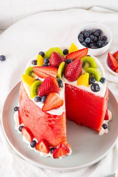 there is a cake with fruit on the top and one slice cut out from it