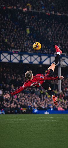 a soccer player in the air catching a ball