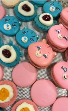 some pink and blue cookies with teddy bears on them are sitting next to each other