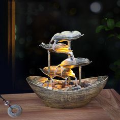 a bowl filled with water sitting on top of a wooden table