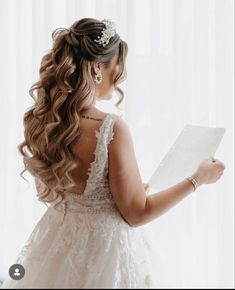 the back of a bride's head holding a piece of paper