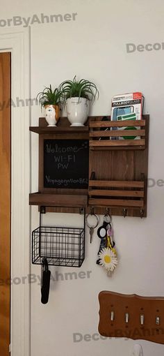 a wall mounted shelf with keys and other items on it next to a wooden door