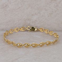 This ladies 14k yellow gold bracelet had 21 links, including the clasp. The links are connected by hinges and pins. This bracelet is 7" in length and 5mm in width at the widest part of the link. It weighs 4.4 grams. Condition: Pre-Owned *All items are thoroughly inspected for quality assurance purposes Classic Gold Hinged Bracelet, Formal Gold Bangle Bracelet With Lobster Clasp, 14k Gold Bracelet With Oyster Clasp, 14k Yellow Gold Hinged Bracelet, 14k Gold Bracelet With Lobster Clasp For Formal Occasions, Elegant Gold Bracelet With Lobster Clasp For Anniversary, Formal 14k Gold Bracelet With Lobster Clasp, Gold Link Bracelets For Anniversary, Gold Anniversary Bracelet With Lobster Clasp