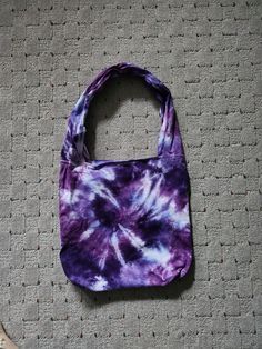 Light, medium and dark purple tie dyed bag. Measures 25 inches from bottom of bag to top of handle.  Bag is 14 inches wide. 2 small pockets are on the inside of the bag.  Item is hand dyed with procion dye and has been prewashed but I still recommend washing separately the first time.    Colors appear differently in different lighting and with different computer monitors. Purple Rectangular Hobo Bag For Daily Use, Everyday Hand Dyed Cotton Bags, Purple Canvas Shoulder Bag For Everyday, Handmade Purple Tote Shoulder Bag, Everyday Hand Dyed Tote Bag, Everyday Hand-dyed Tote Bag, Purple Everyday Canvas Shoulder Bag, Casual Purple Tote Bag, Casual Handmade Purple Shoulder Bag