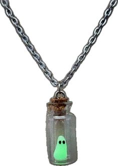 a glass bottle with a ghost inside on a chain