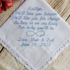 a wedding handkerchief with the words, we'll love you forever and our baby