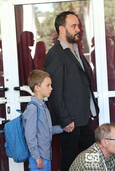 a man and boy are standing in front of a door