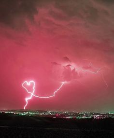 a lightning bolt hitting the sky over a city