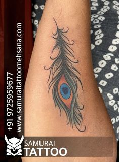 a woman's arm with a peacock feather tattoo on the left side of her arm