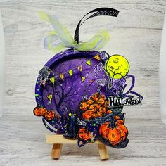 a purple pumpkin decorated with halloween decorations