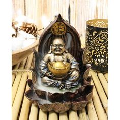 a buddha statue sitting on top of a wooden table