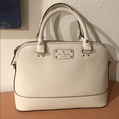 9 Inch Height, 13 Inch Width Across One Side, 4,5 Inch Depth . Nwot, Comes With Crossbody Strap. Ivory White 100% Cow Leather Exterior. Pink Polka Dot Interior. With Dust Bag. Classic White Handheld Bag, White Handheld Bag With Gold-tone Hardware, Classic White Handheld Satchel, Kate Spade Beige Satchel With Double Handle, Kate Spade Beige Double Handle Satchel, Kate Spade Cream Bag With Adjustable Strap, Kate Spade Cream Bag With Gold-tone Hardware, Classic White Kate Spade Shoulder Bag, White Luxury Kate Spade Shoulder Bag