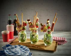 several mason jars filled with food sitting on top of a table