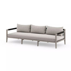 an image of a couch with pillows on the back and arms, in grey fabric