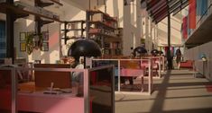 an office filled with lots of desks and chairs next to each other in front of bookshelves