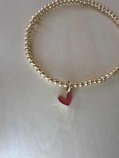 This 14kt gold filled bracelet is sure to be the perfect addition to your stack.  4mm beads are strung on durable elastic string with letter of your choice. Please measure wrist and add .5" for comfort.  This listing is for one bracelet. Happy Stacking! Adjustable Gold Heart Bracelet With Tiny Beads, Gold Heart Bracelet With Tiny Beads For Gift, Gold Heart Bracelet With Tiny Beads As Gift, Heart Shaped Beaded Gold Bracelets, Gold Beaded Heart-shaped Bracelets, Gold Beaded Heart Shaped Bracelets, Heart-shaped Gold Beaded Bracelets, Gold Heart-shaped Beaded Bracelets, Gold Charm Bracelet With Heart Beads