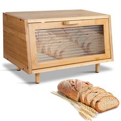 a loaf of bread sitting on top of a table next to a wooden box with the lid open