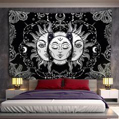 the sun and moon wall tapestry is hanging above a bed