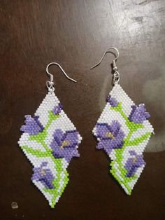 the beaded earrings have purple flowers on them