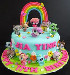 a birthday cake decorated with littlest pet shop toys