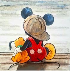 a drawing of a mickey mouse sitting on top of a wooden table with a hat