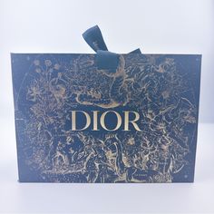 a blue box with gold lettering that says dior on it and an image of people in the background