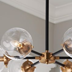 a chandelier with five clear glass globes hanging from it