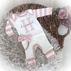 This precious personalized ivory romper with pink striped sleeves and cuffs is perfect for bringing baby home or first photos. It features your baby's initial and name. optional headband is available. Made in ultra soft ribbed cotton.  PLEASE NOTE:  Many of these items contain small parts which could be unsafe for children if left unsupervised.  Please do not leave your child unattended when wearing to prevent any possible choking hazards.  We love your children and want to keep them safe. Personalized Pink Onesie For First Birthday, Pink Cotton Baptism Onesie, Bringing Baby Home, Personalized Baby Girl, Striped Sleeve, Baby Romper, First Photo, Girls Clothing, Love Your