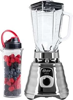 a blender with berries in it next to a glass container filled with water and strawberries