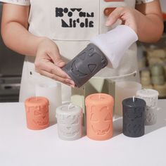 a woman is making candles in the kitchen for someone to make them look like they are pouring out some liquid