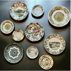 a table topped with lots of plates covered in different colors and designs on top of each other