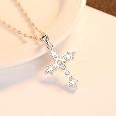 Our dainty Cross necklace is simply beautiful. This necklace features an exquisite cross pendant on a twist chain. 925 Sterling Silver hypoallergenic CZ Pendant Size: 2.7cm x 1.6cm Necklace length: 40cm + 5cm White Gold Cross Necklace With Clavicle Chain, Sterling Silver Clavicle Chain Cross Necklace, White Gold Cross Necklace With Adjustable Chain, Silver Cross Necklace With Clavicle Chain, Sterling Silver Cross Necklace With Clavicle Chain, Dainty White Gold Cross Necklace, Cross Pendant Necklace Woman, Dainty Cross Necklace, Heartbeat Necklace