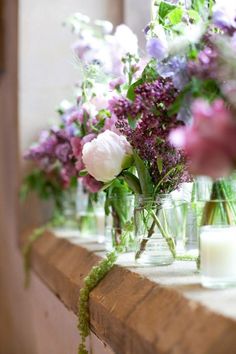 several vases filled with different types of flowers