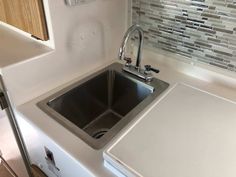 a kitchen sink with a faucet next to it