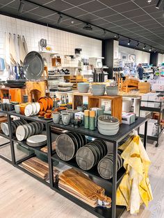 a kitchen filled with lots of pots and pans on top of a metal shelf