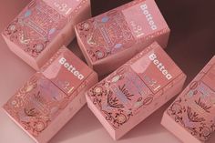 six pink boxes with designs on them sitting next to each other in front of a gray background