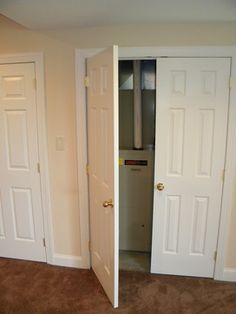 an empty room with two doors open and carpeted flooring in the foreground