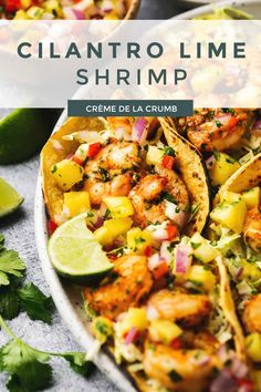 shrimp and pineapple salsa in a white bowl with lime wedges on the side