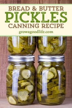 two jars filled with pickles sitting on top of a wooden table