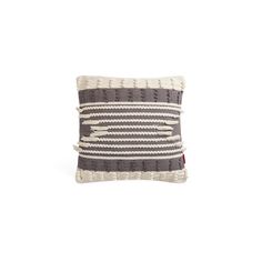 a black and white striped pillow with fringes on the front, sitting against a white background