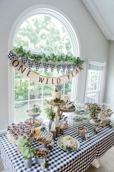 a black and white checkered table cloth topped with desserts