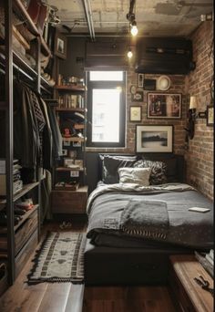 a bedroom with a brick wall and lots of clothes hanging on the shelves in it