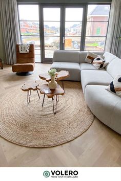 a living room filled with furniture and a large window