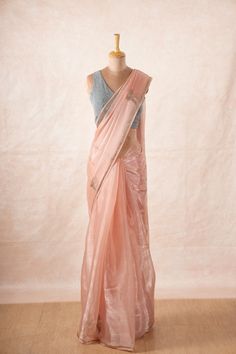 The sheer beauty of this saree is unparalleled, with its delicate and lightweight chinon chiffon fabric that drapes effortlessly to create a mesmerizing silhouette. Material: Chinon Chiffon Embellishments: Motifs, borders and pallu embellished with Swarovski stones and tassels. Color: Light Pink Saree Size: 1.12 x 5.6 metres Blouse: Attached blouse material  (0.88 metres approx) Display: The mannequin is draped in our pink chinon chiffon saree with our grey glitter blouse. Colors Available: 3 Art Silk Pre-draped Saree With Sheer Dupatta, Pink Chanderi Pre-draped Saree With Sheer Dupatta, Organza Saree With Zari Weaving For Party, Party Saree With Zari Weaving In Organza, Organza Saree For Navratri, Pink Silk Saree For Party Wear, Pink Silk Party Wear Saree, Dola Silk Pre-draped Saree For Party Wear, Pink Organza Blouse Piece With Self Design