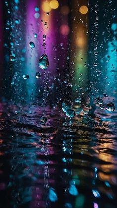 rain drops on the window with colorful lights in the background