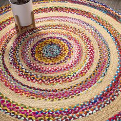 a multicolored rug with a potted plant on top