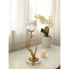 a glass candle holder on a white table